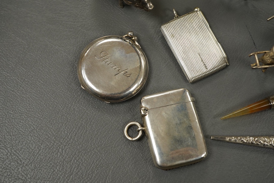 Sundry small silver and other items including a pig pin cushion, Adie & Lovekin, Birmingham, 1906, 45mm, a silver circular stamp case, a silver vesta case, a small sterling mounted notecase, three small metal rickshaws,